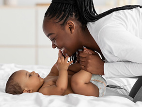 African American mother playing with baby