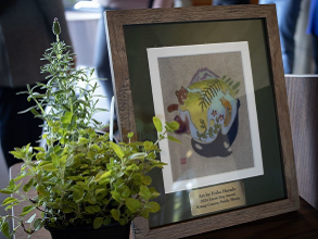 2024 Earth Day Awards art by Erika Harada, framed art of whale, bird, and mountain around earth